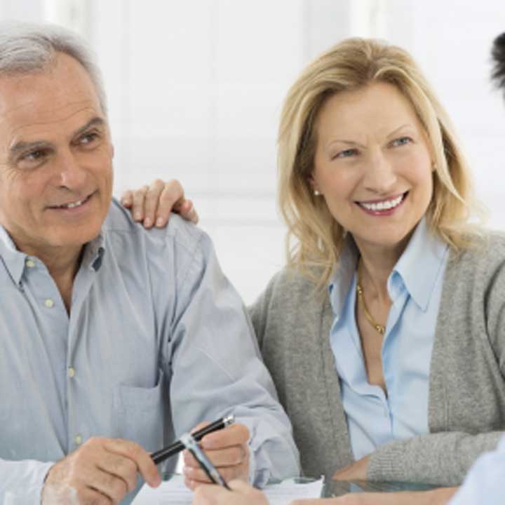 Mature couple with women's hand on man's shoulder