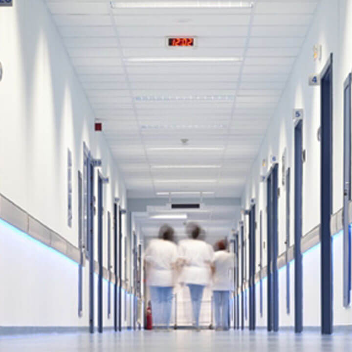 Hospital corridor with nurses in distance blurred