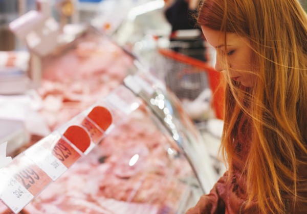 Young woman buying meat
