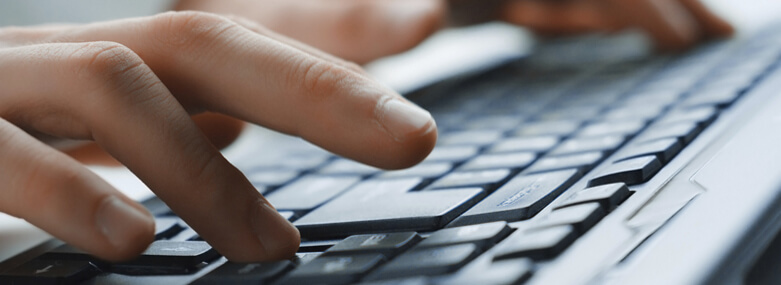 Image of man's hands typing.