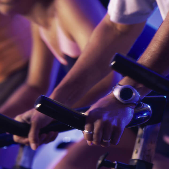 people cycling in a gym