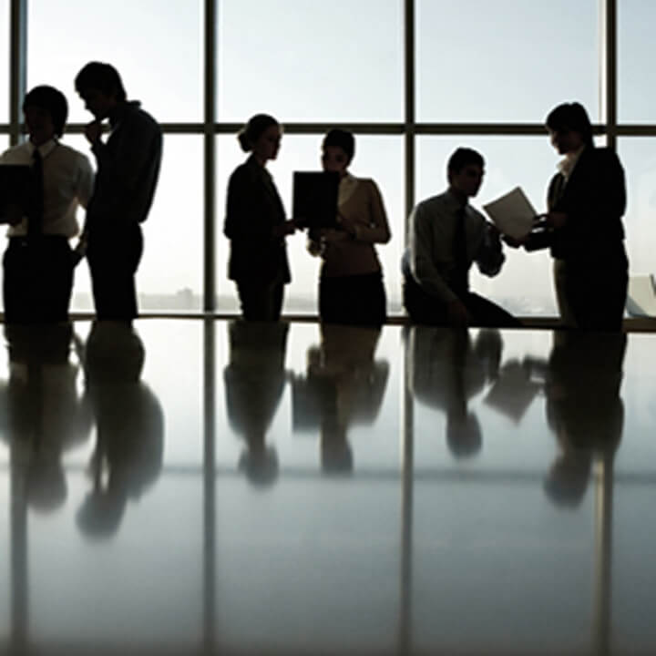 backlit business people around a table