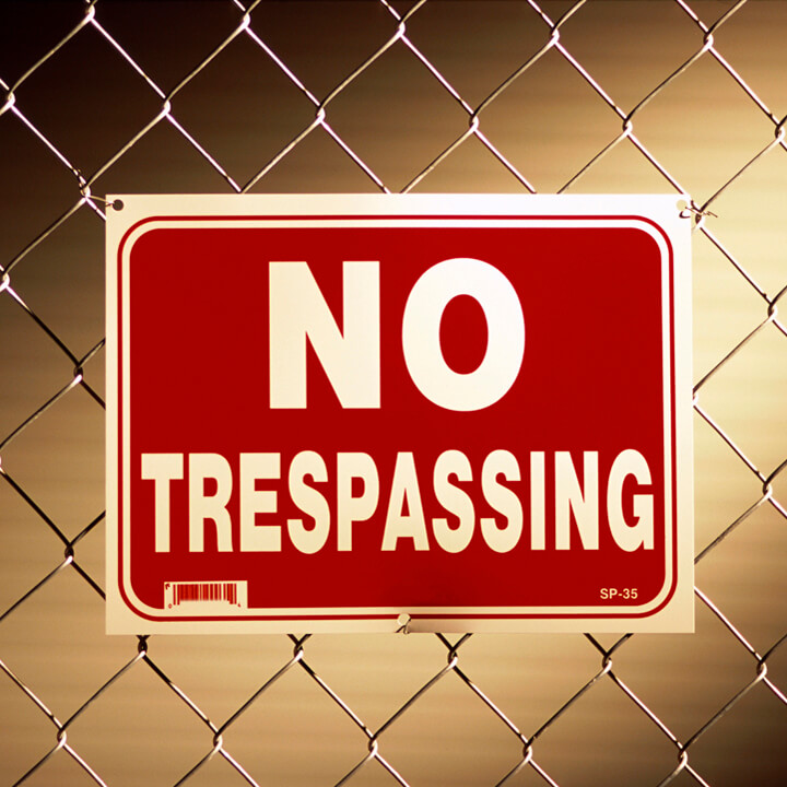 No trespassing sign on a chain-link fence
