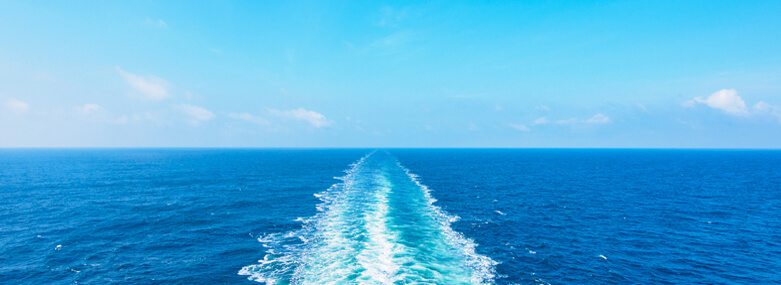 Ocean wake from cruise ship, on bright summer day.