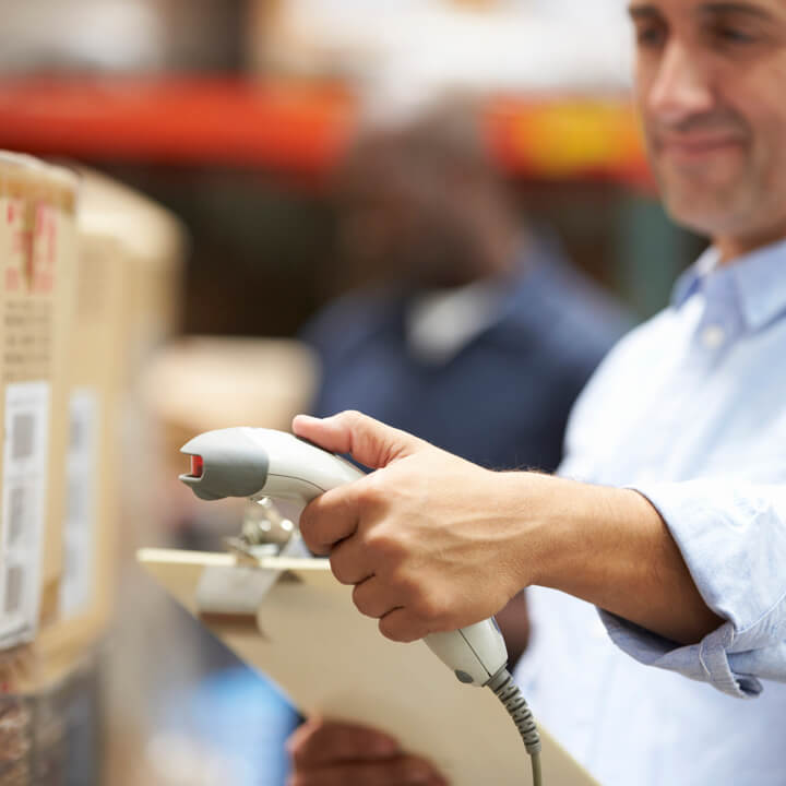 Worker Scanning Package In Warehouse