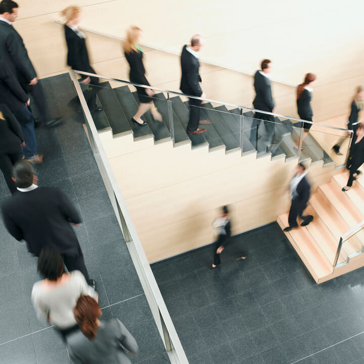 Businesspeople walking down office staircase
