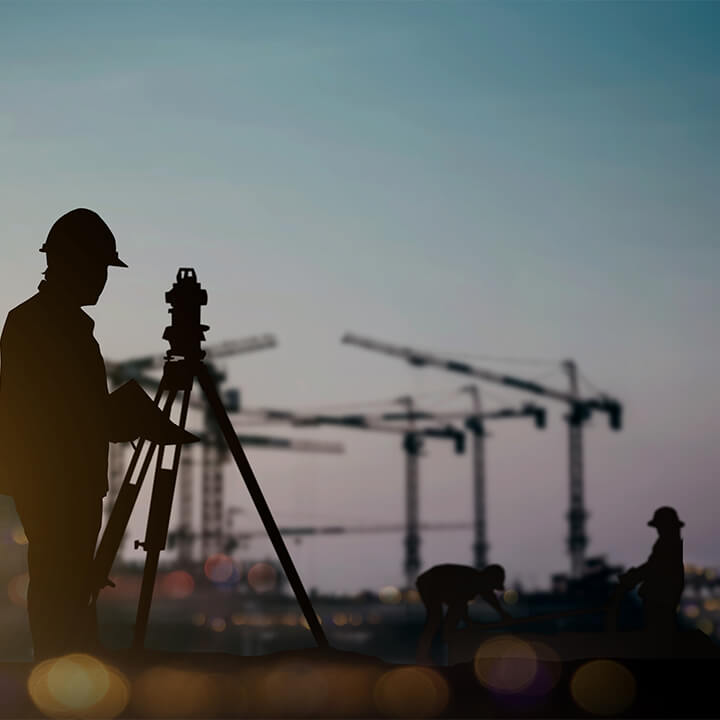 silhouette_engineer_looking_Loaders_and_trucks_in_a_building_site_over_Blurred_construction_worker_on_construction_site