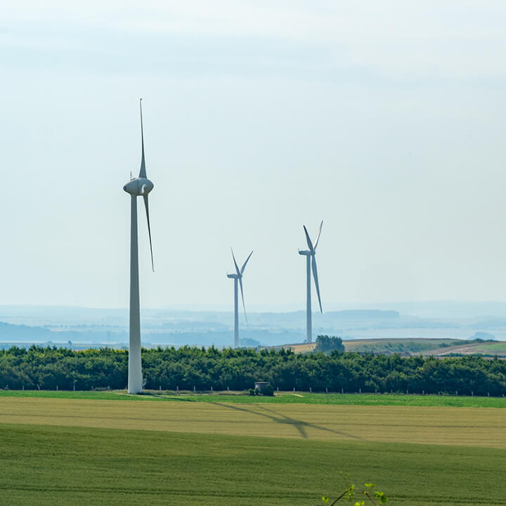 Three wind turbines in a field