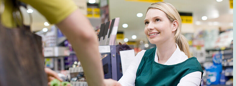 Female-cashier-and-customer-at-supermarket-checkout