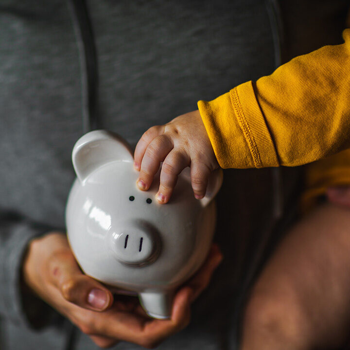 Parent-and-child-holding-piggy-bank