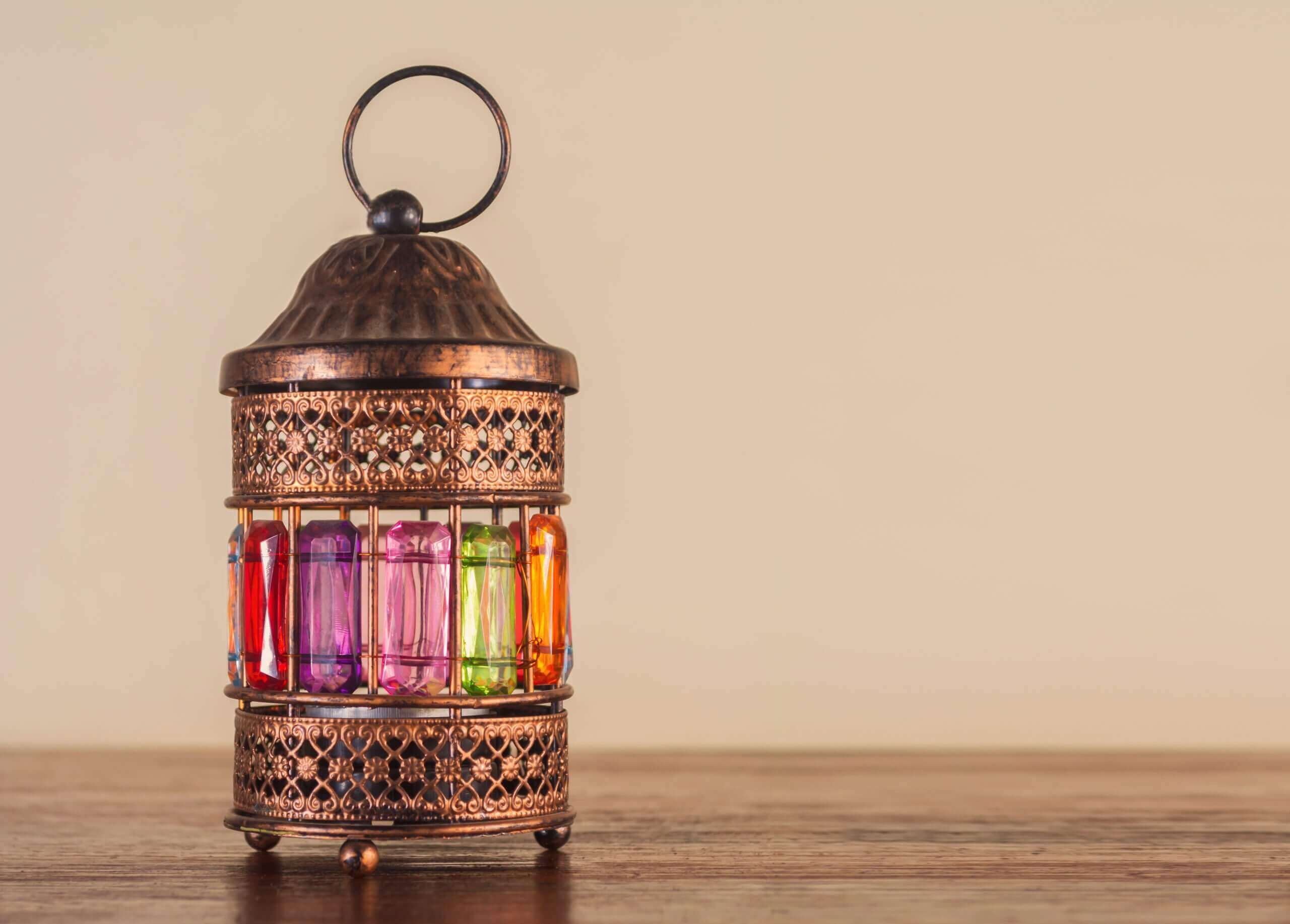 Colorful Ramadan lantern on a wooden table with a copy space for design or texts , Ramadan Kareem