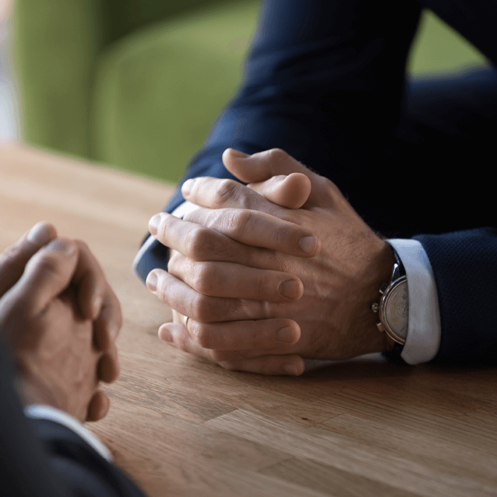 hands of two men taking part in dispute resolution