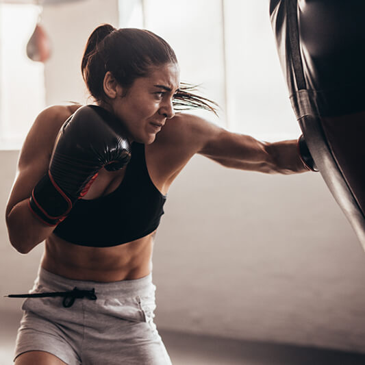 a young woman boxing in the gym