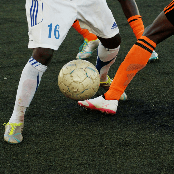 two footballers tackling each other