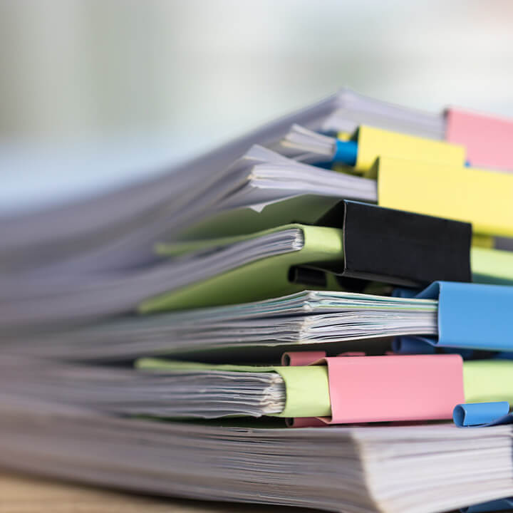 Pile-of-documents-in-binders