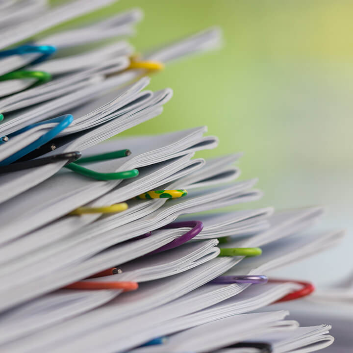 pile-of-procurement- documents-with-coloured-paper-clips