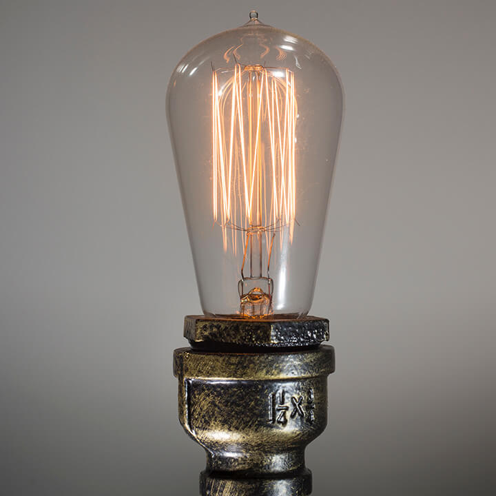 Dim-lightbulb-on-a-brass-stand