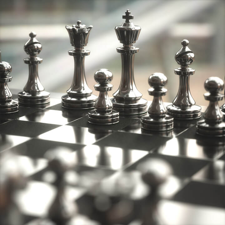 Image of a chess board, with pieces poised against each other. A visual metaphor for the topic of this piece, dispute escalation clauses.