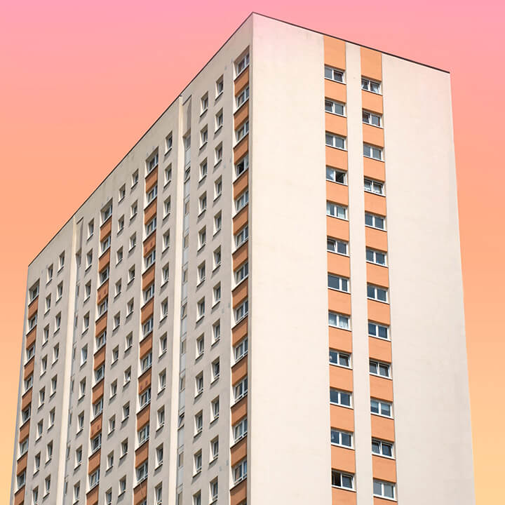 An image of a block of flats, with a sunset behind it, going from yellow to rose pink. A visual metaphor for the topic of this article. URS Corporation Ltd V BDW Trading Ltd [2023]