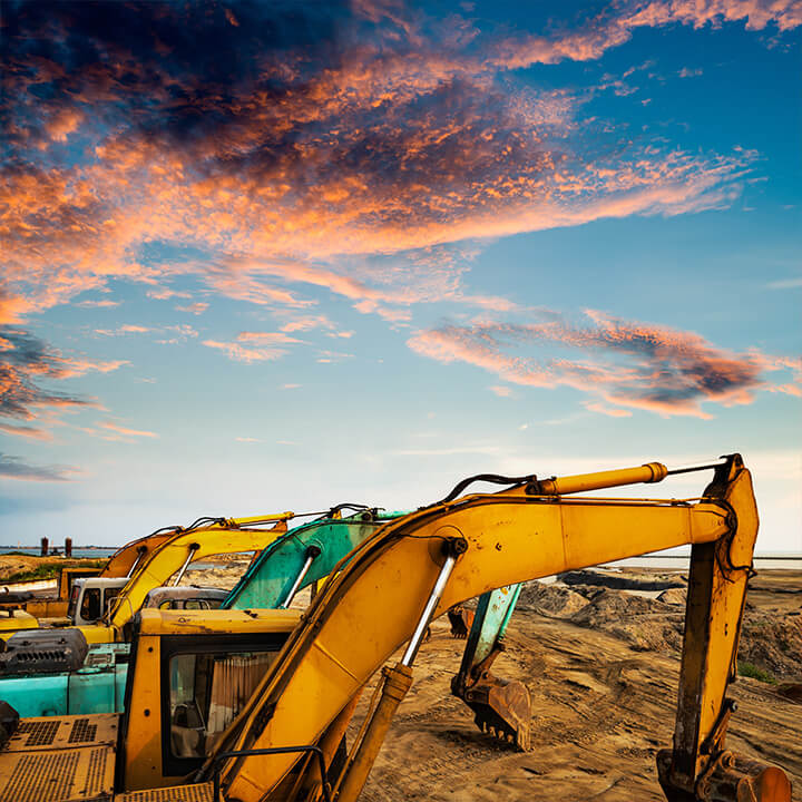An image of a set of diggers on a worksite at sunset. A visual metaphor for the topic of the piece, an introduction to environmental law in practice.