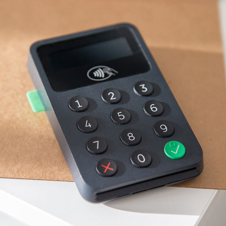 An image of a card machine on a desk. A visual metaphor for the topic of this post, the new rules around tips and hospitality.
